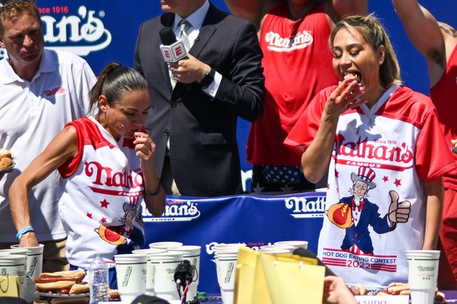 Defending champion Miki Sudo, right, and second-place winner, Michelle Lesko compete in the 2022 Nathan's Famous Fourth of July International Hot Dog Eating Contest in Coney Island.